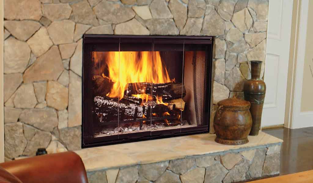 12 Cozy & Beautiful Fireplaces http://www.beautifuldesignmadesimple.com large stone fireplace with built-in wood storage warms a tile floor Photo: Gel Fireplaces